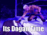 a man is kneeling down in a wrestling ring with the words " its dagan time " written above him