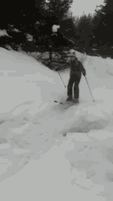 a person is skiing down a snow covered slope with their arms in the air