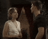 a man and a woman are standing next to each other