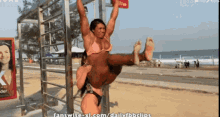 a screen shot from fanswise-xl.com shows a woman carrying another woman on her shoulders