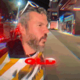 a man with a beard wearing sunglasses and a shirt that says old on it