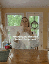 a woman is wrapping a father 's day present