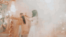a woman in a white crop top is dancing with her arms outstretched