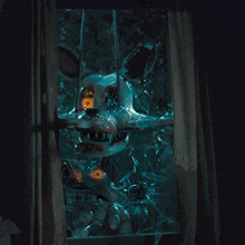 a broken glass window with a cartoon character behind it