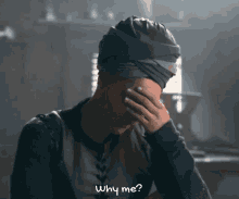 a woman in a turban is covering her face with her hand and the words why me are written below her
