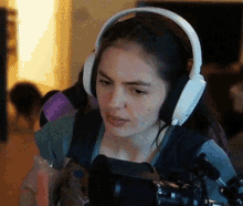 a woman wearing headphones is looking at something