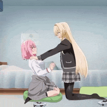 a girl with pink hair is kneeling down next to another girl with blonde hair
