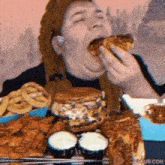 a man is eating a hamburger and french fries at a restaurant