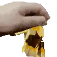 a hand is holding a piece of chocolate with a bite taken out of it