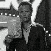 a man in a suit is holding a card that says happy holidays lucky 38