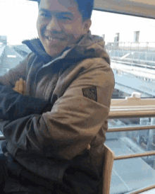 a man wearing a jacket with a badge on the sleeve that says ' prada ' on it