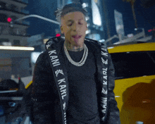 a man wearing a black jacket with karl on it