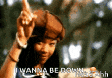 a girl wearing a hat is pointing up and says i wanna be down