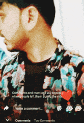a man in a floral shirt is standing in front of a screen that says write a comment on it