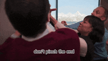 a man is pointing at a woman while another man says do n't pinch the end