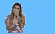 a woman covering her mouth with her hands in front of a blue background that says thank you so very much