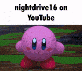 a pink kirby is standing on a green field with the words nightdrive 16 on youtube above him .