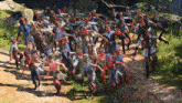a large group of zombies are running down a dirt road