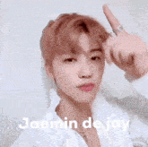 a young man with red hair is making a funny face and giving the middle finger .