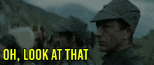 a man in a military uniform stands in front of a group of people and says uh look at that