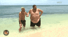 two men are standing in the water with giorno 17 on the bottom right