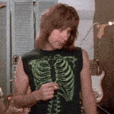 a man wearing a black shirt with a skeleton design on it