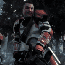 a man in a red and white armor with the letter u on it