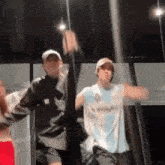 a group of people are dancing on a stage in a room .