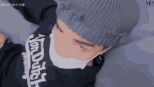 a man wearing a mask and a sweater that says von dutch on it