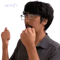 a man with glasses and a beard is making a gesture with his hands