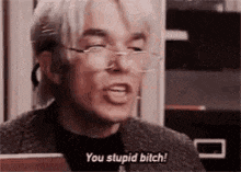 a man wearing glasses is talking and saying `` you stupid bitch ! ''