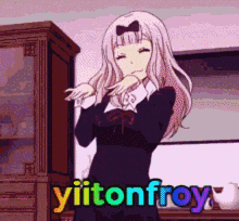 a girl with a bow on her head is standing in front of a cabinet with the words yiitonfroy written on it .