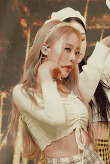 a woman wearing a headband that says ' i love you ' on it is singing into a microphone