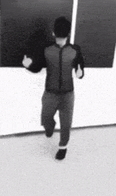 a man in a black and white photo is running