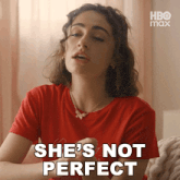 a woman in a red shirt with the words she 's not perfect above her