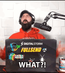 a man wearing headphones is standing in front of a laptop that says fullsend on it