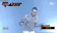 a man is dancing on a stage in front of a mnet banner