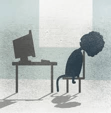 a silhouette of a person sitting in front of a computer desk .