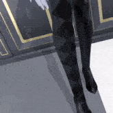 a person wearing black boots with a diamond on the heel