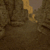 a scorpion is crawling through a canyon with rocks