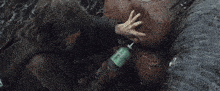 a man with long hair and a beard drinking from a bottle