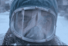 a close up of a person wearing a helmet and goggles