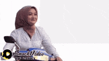 a woman wearing a hijab is riding a motorcycle with the year 2024 on the bottom