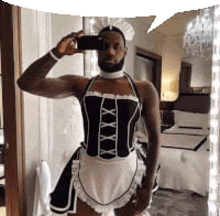 a man in a maid costume is taking a selfie with his phone .