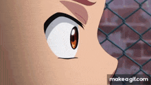 a close up of a cartoon character 's eye with a fence in the background .