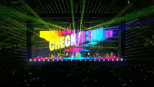 a crowd of people are watching a concert with a large screen behind them that says ' i love you '