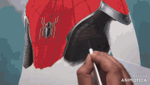 a person is painting a spider man suit with a brush