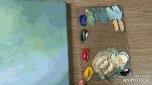 a palette of paint is on a table next to a painting