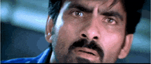 a close up of a man 's face with a mustache
