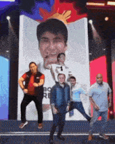 a group of men are posing for a picture in front of a poster that says bo